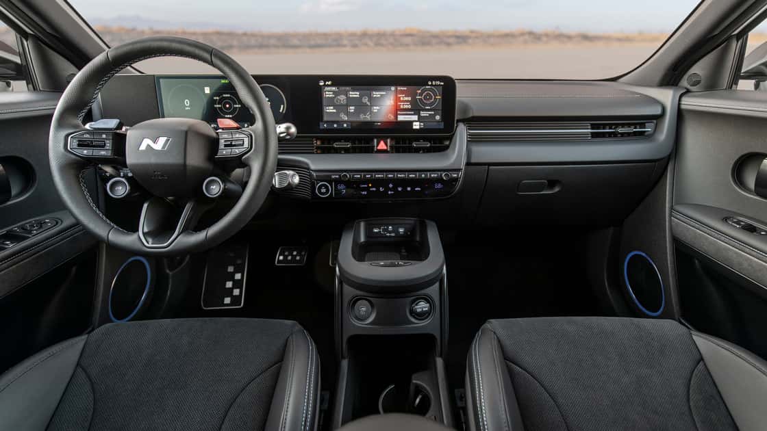 2026 Hyundai IONIQ 5 N interior with N steering wheel, dual digital displays, sport controls, and black cabin trim.