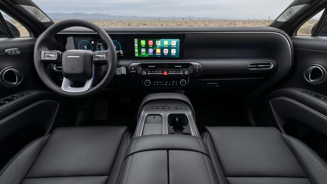 2026 Hyundai Palisade interior with wide digital display, black dashboard, wireless connectivity, and modern front cabin layout.