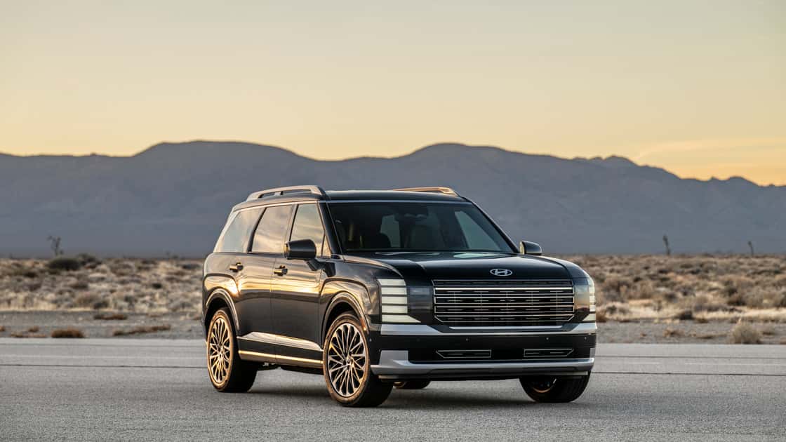 2026 Hyundai Palisade black three-row SUV parked in a desert setting with LED lighting and wide front grille.