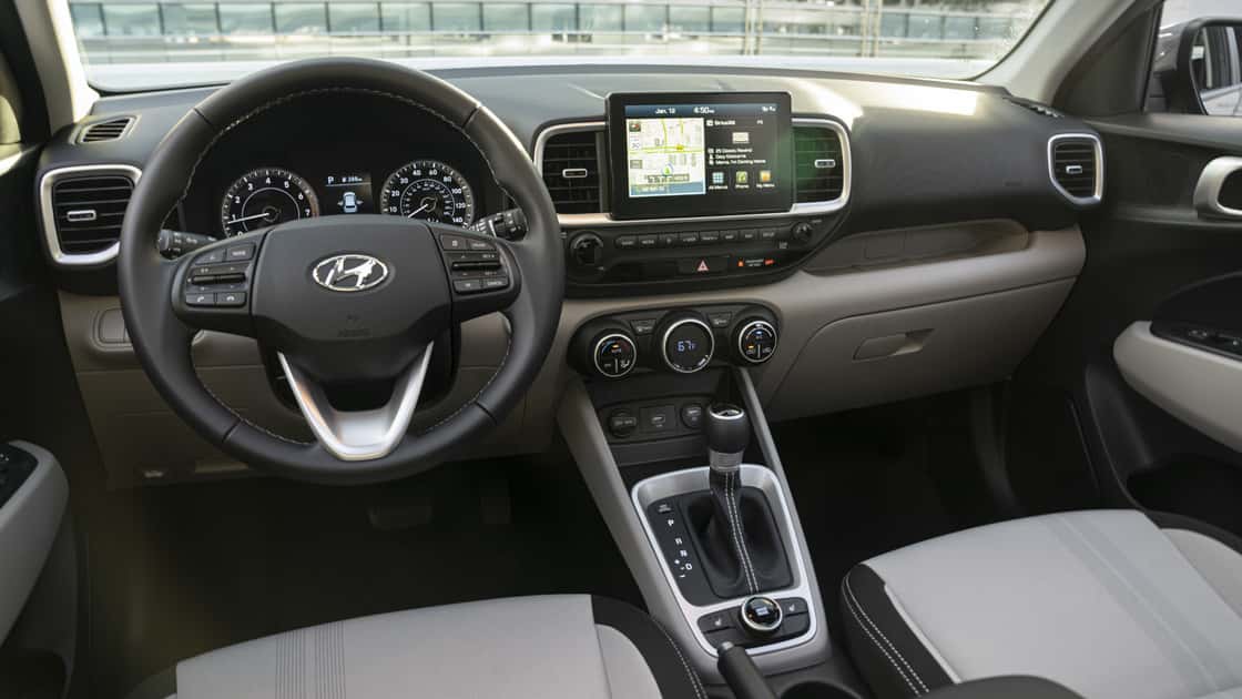 2026 Hyundai Venue interior with steering wheel, touchscreen navigation, climate controls, and compact cabin layout.