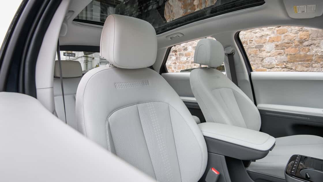 2026 Hyundai Kona front seats with light gray upholstery, spacious cabin layout, and clean interior styling.