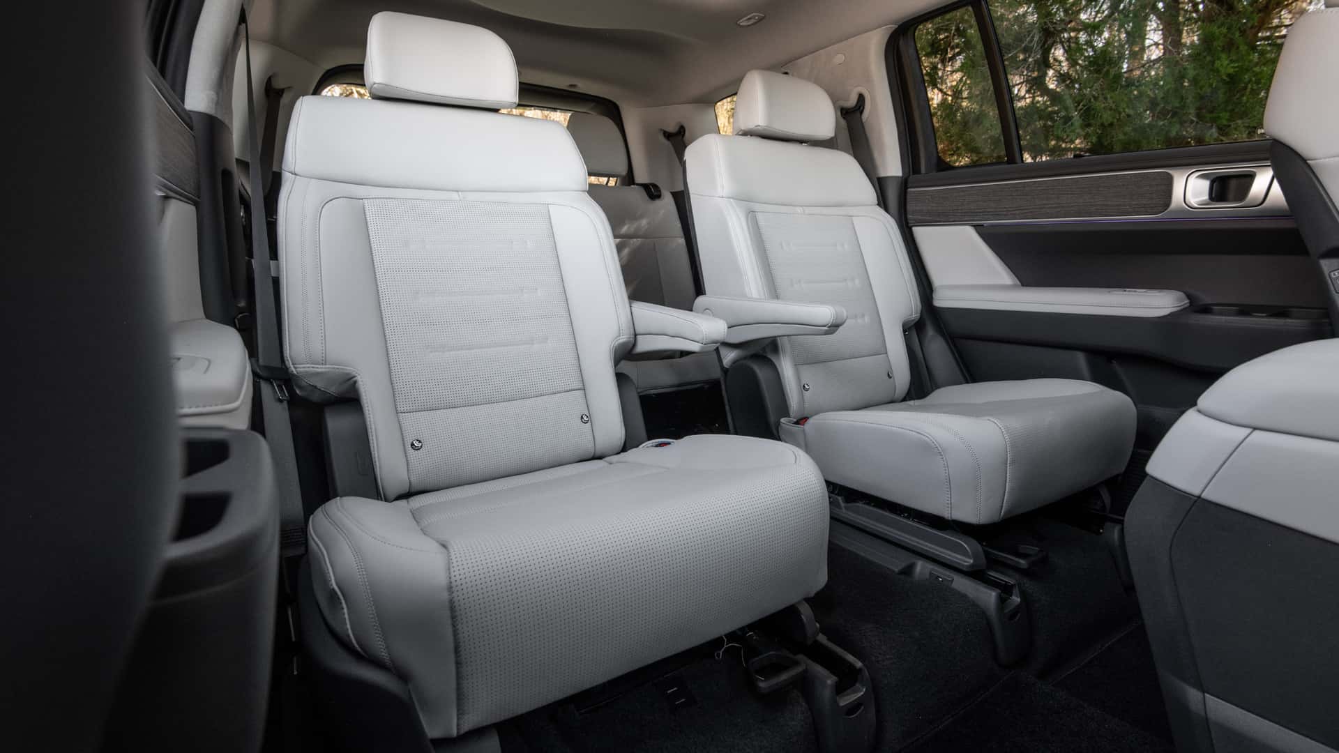 2026 Hyundai Santa Fe second-row seats with light upholstery, armrests, and spacious passenger cabin design.
