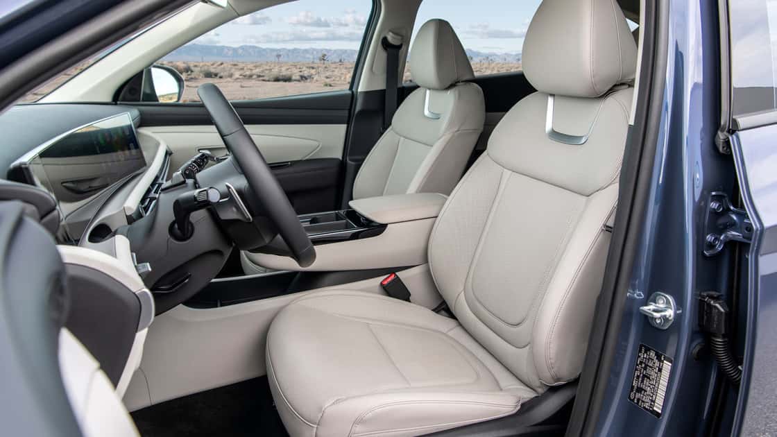 2026 Hyundai Tucson front seats with light upholstery, modern console design, and spacious SUV cabin layout.