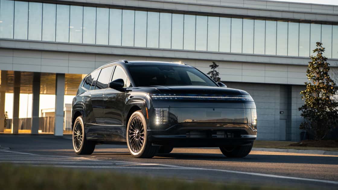 2027 Hyundai IONIQ 9 black electric SUV parked near a modern building with pixel-style lighting and bold three-row design.