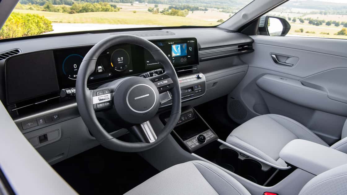 2027 Hyundai Kona interior with digital gauges, touchscreen display, and light gray seating.