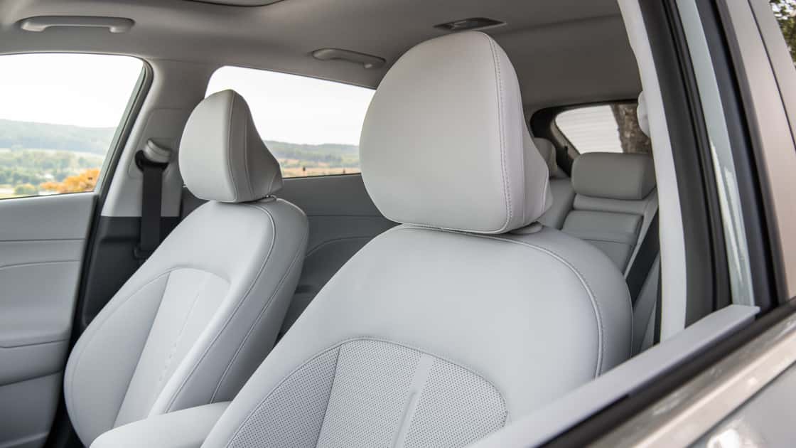 2027 Hyundai Kona front seats with light gray upholstery, headrests, and open cabin view.