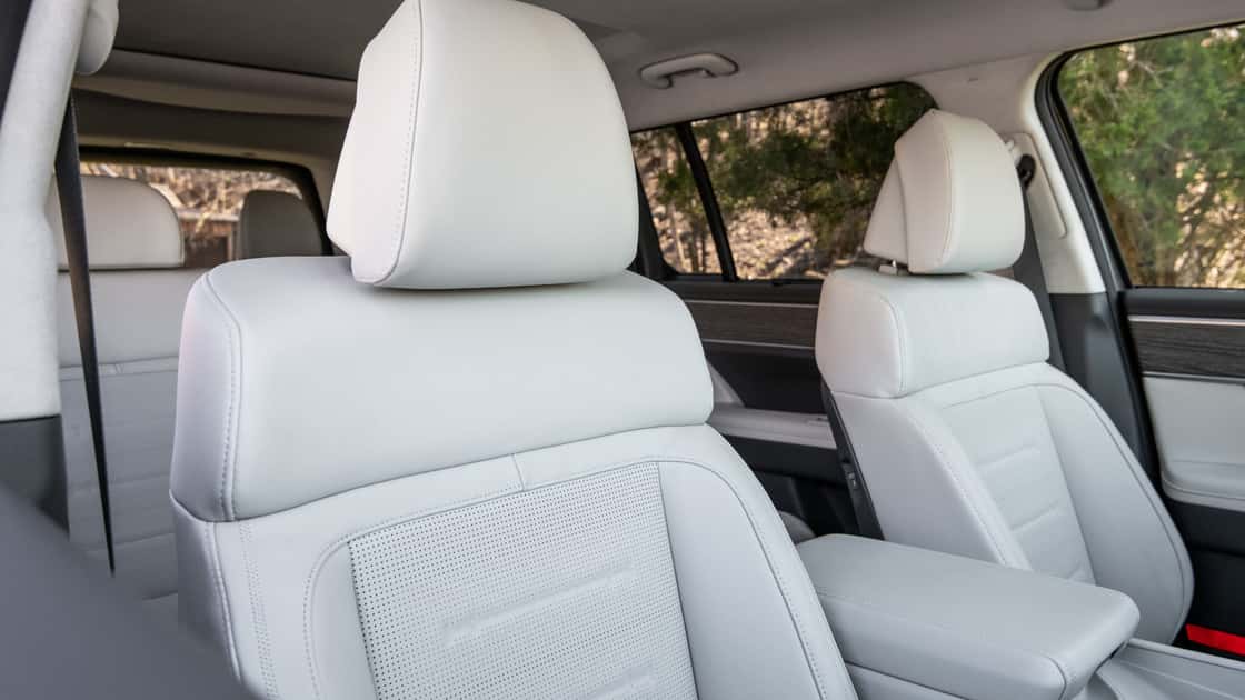 2027 Hyundai Santa Fe front seats with light upholstery, center armrest, and upscale cabin details.