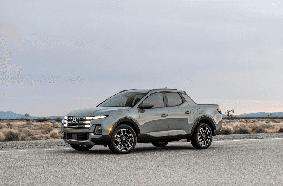 2025 Hyundai Santa Cruz parked on desert road showcasing LED lights and bold grille design
