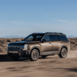 2026 Hyundai Palisade SUV driving on a dusty desert trail with rugged off-road styling.