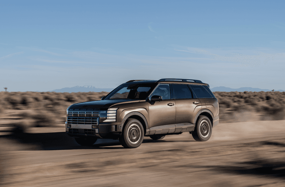 2026 Hyundai Palisade SUV driving on a dusty desert trail with rugged off-road styling.