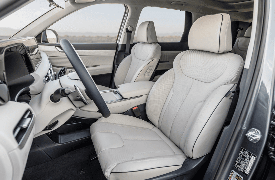 2025 Hyundai Palisade front interior showcasing premium leather seats and modern dashboard layout.
