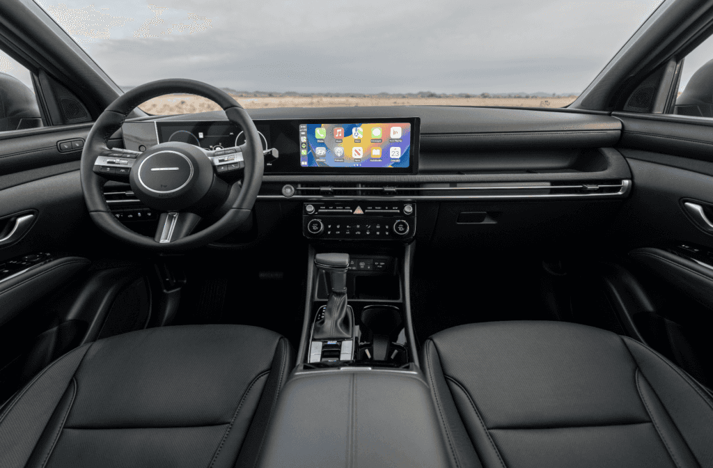 2026 Hyundai Santa Cruz interior with black leather seats, panoramic digital display, and modern console.