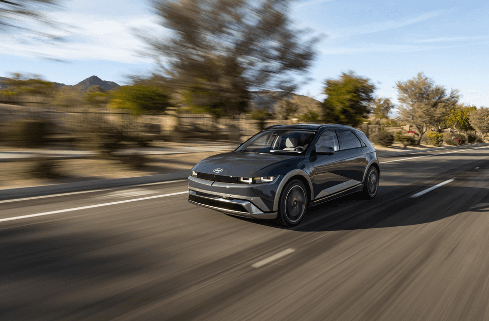 2025 Hyundai IONIQ 5 electric SUV in motion on city street with blurred background.
