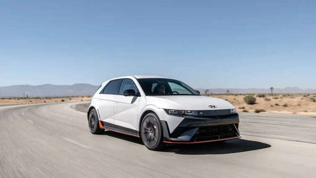 White 2026 Hyundai IONIQ 5 N driving on desert road showcasing sporty electric performance.