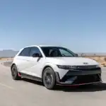 White 2026 Hyundai IONIQ 5 N driving on desert road showcasing sporty electric performance.