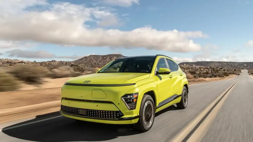 Yellow 2026 Hyundai Kona Electric cruising on open road highlighting modern EV design.