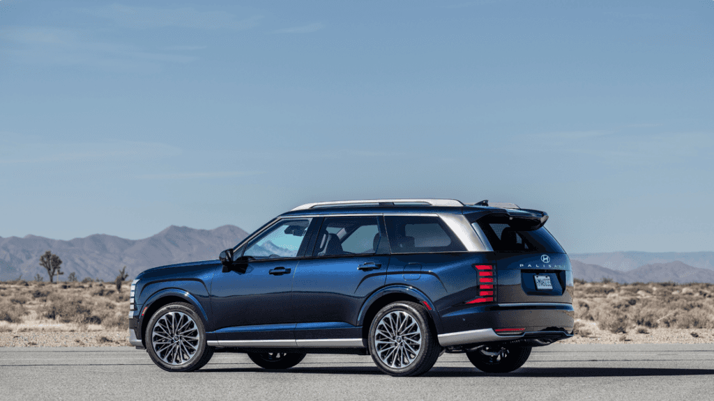 2026 Hyundai Palisade blue exterior side profile SUV parked in desert landscape.