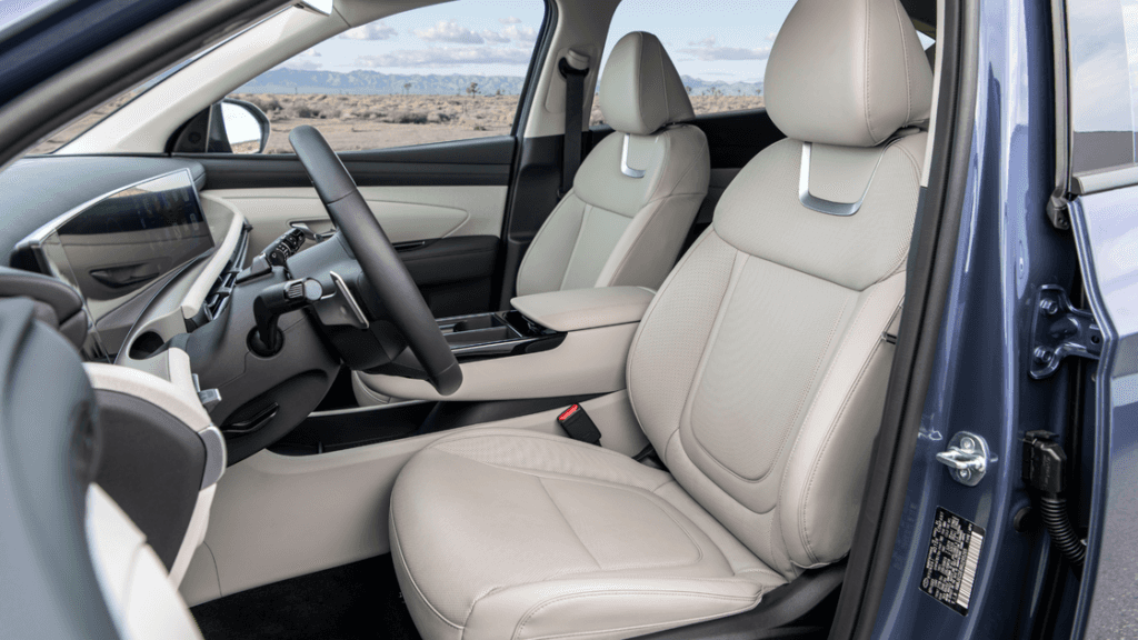 2026 Hyundai Tucson light gray front seats with center console and steering wheel.