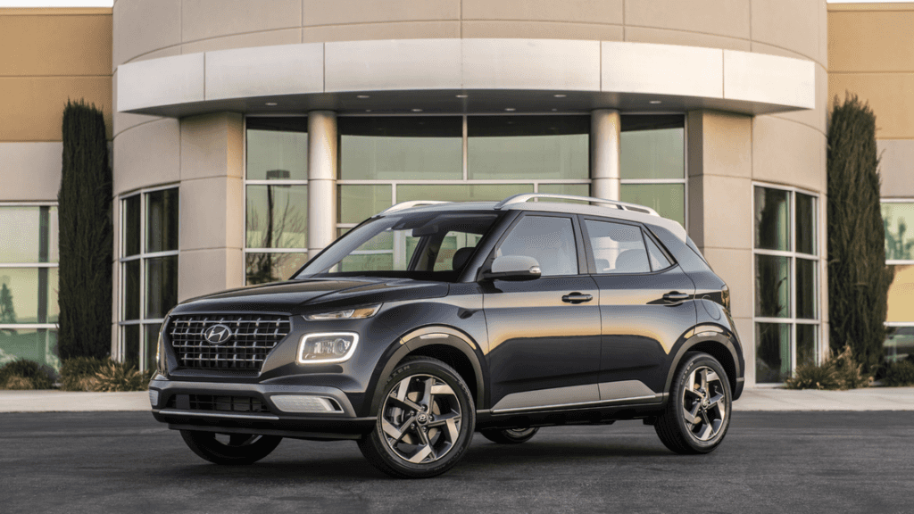 2026 Hyundai Venue dark gray exterior front three quarter view parked outside building.