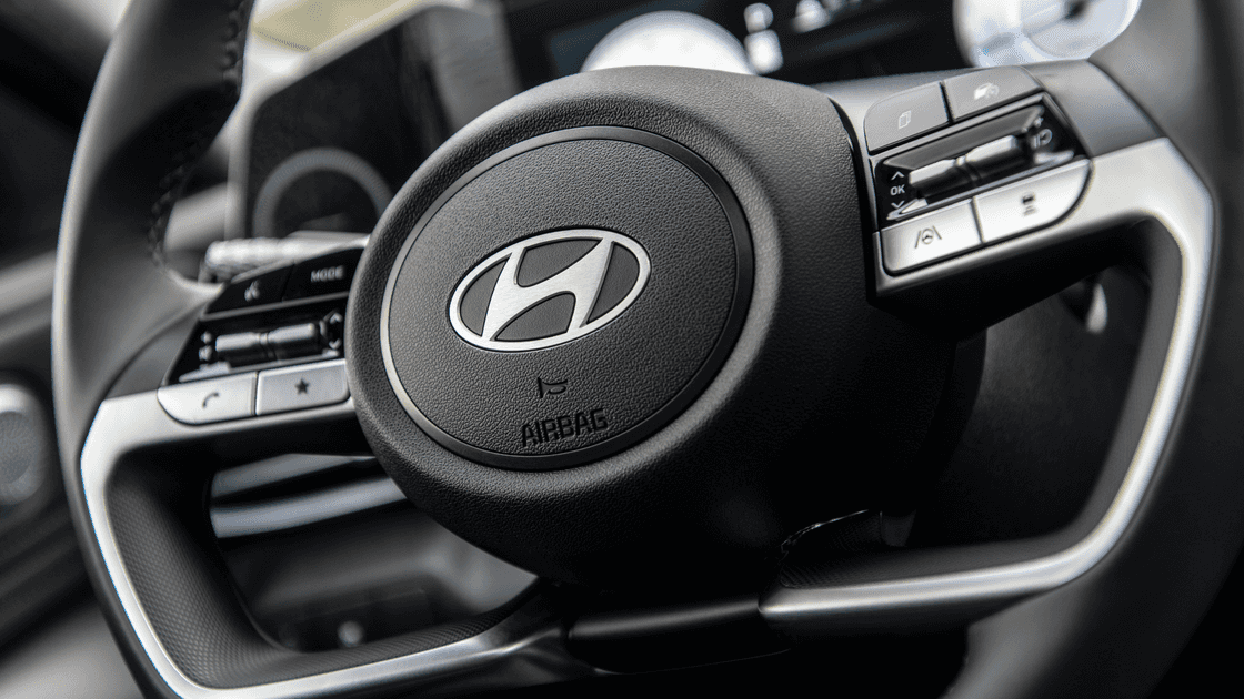 2026 Hyundai Elantra steering wheel close up showing Hyundai logo and control buttons.