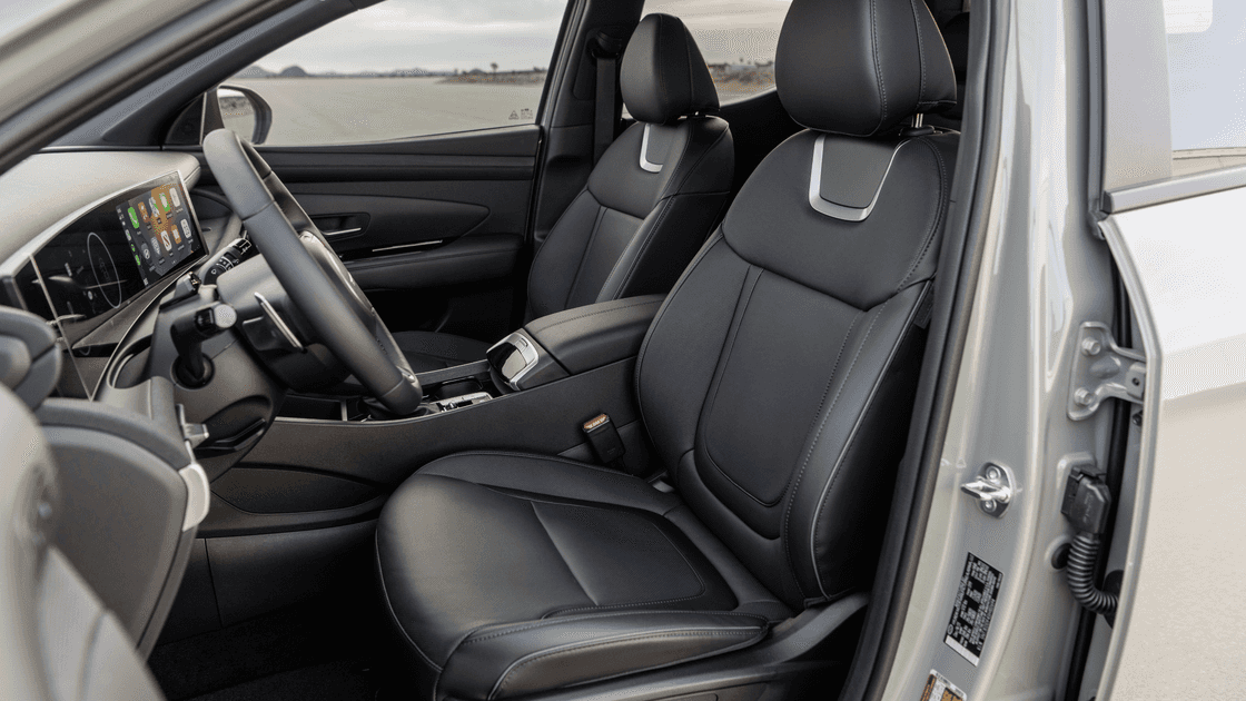 2026 Hyundai Santa Cruz interior front seats with black leather upholstery and console.