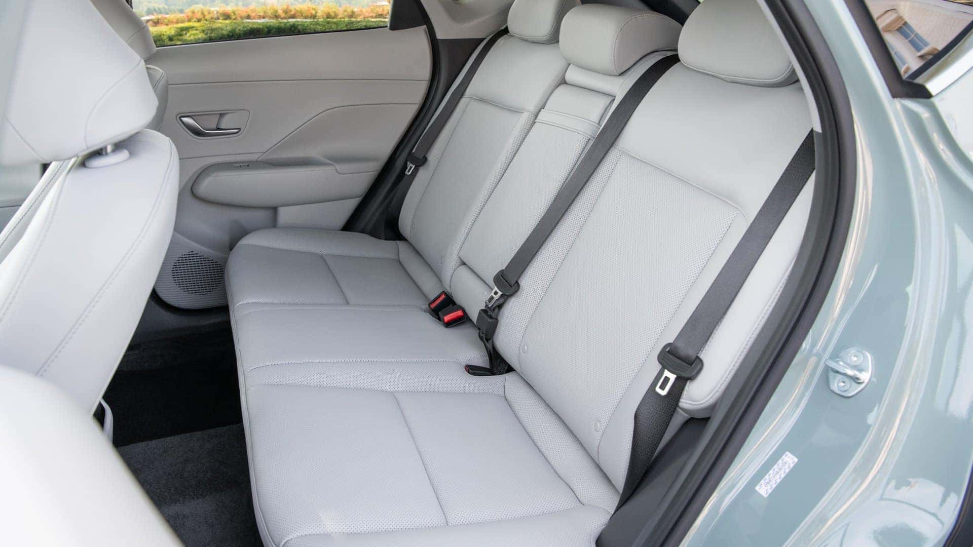 2026 Hyundai Kona rear passenger seating with contoured seats, seatbelts, and spacious legroom.