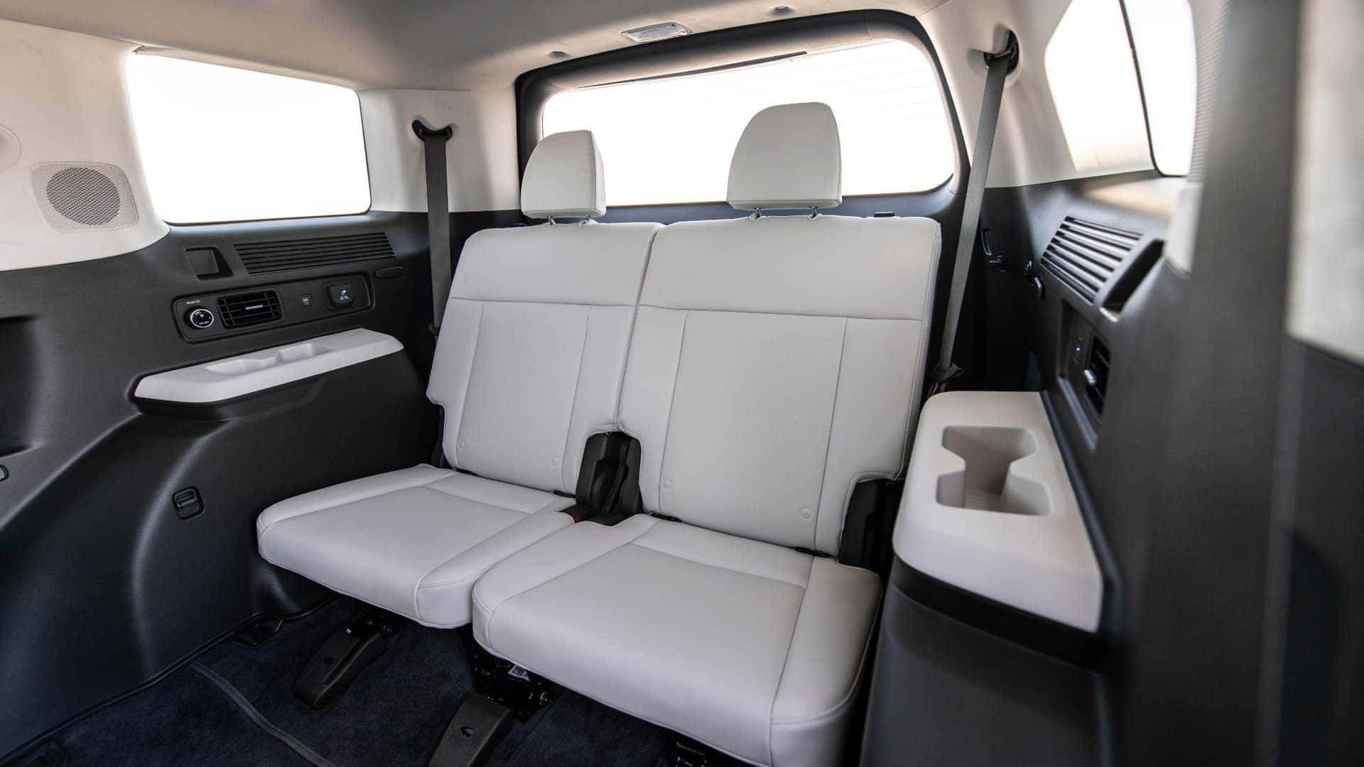 2026 Hyundai Santa Fe Hybrid third-row seating area with fold-down seats, rear climate vents, and cargo versatility.