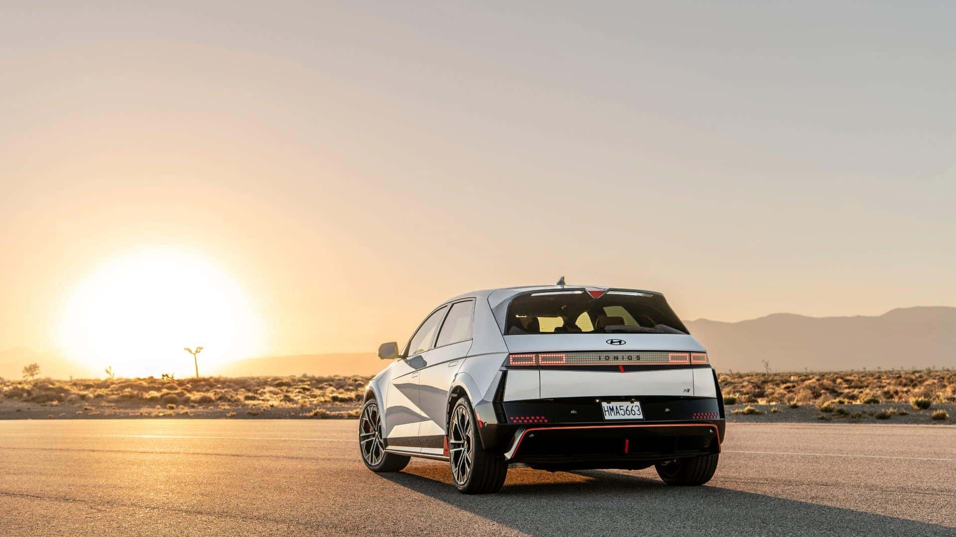 2026 Hyundai IONIQ 5 N electric performance hatchback parked on a desert road at sunset.