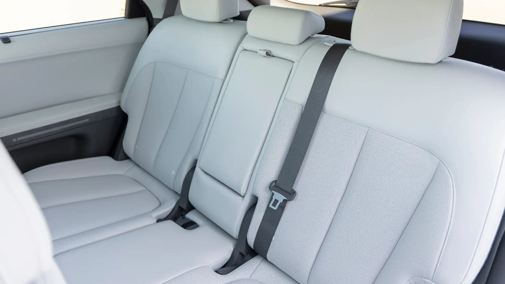 2026 Hyundai IONIQ 5 rear seat interior with light upholstery and fold down center armrest.