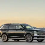 2026 Hyundai Palisade SUV parked in side profile with black exterior and large alloy wheels.