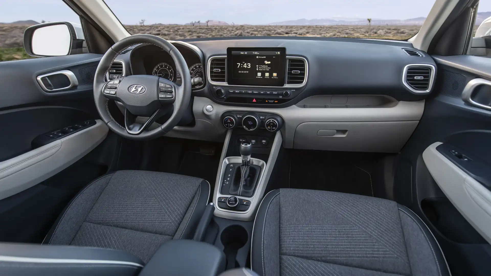 2026 Hyundai Venue gray cabin with touchscreen display, cloth seats, and compact dashboard layout.