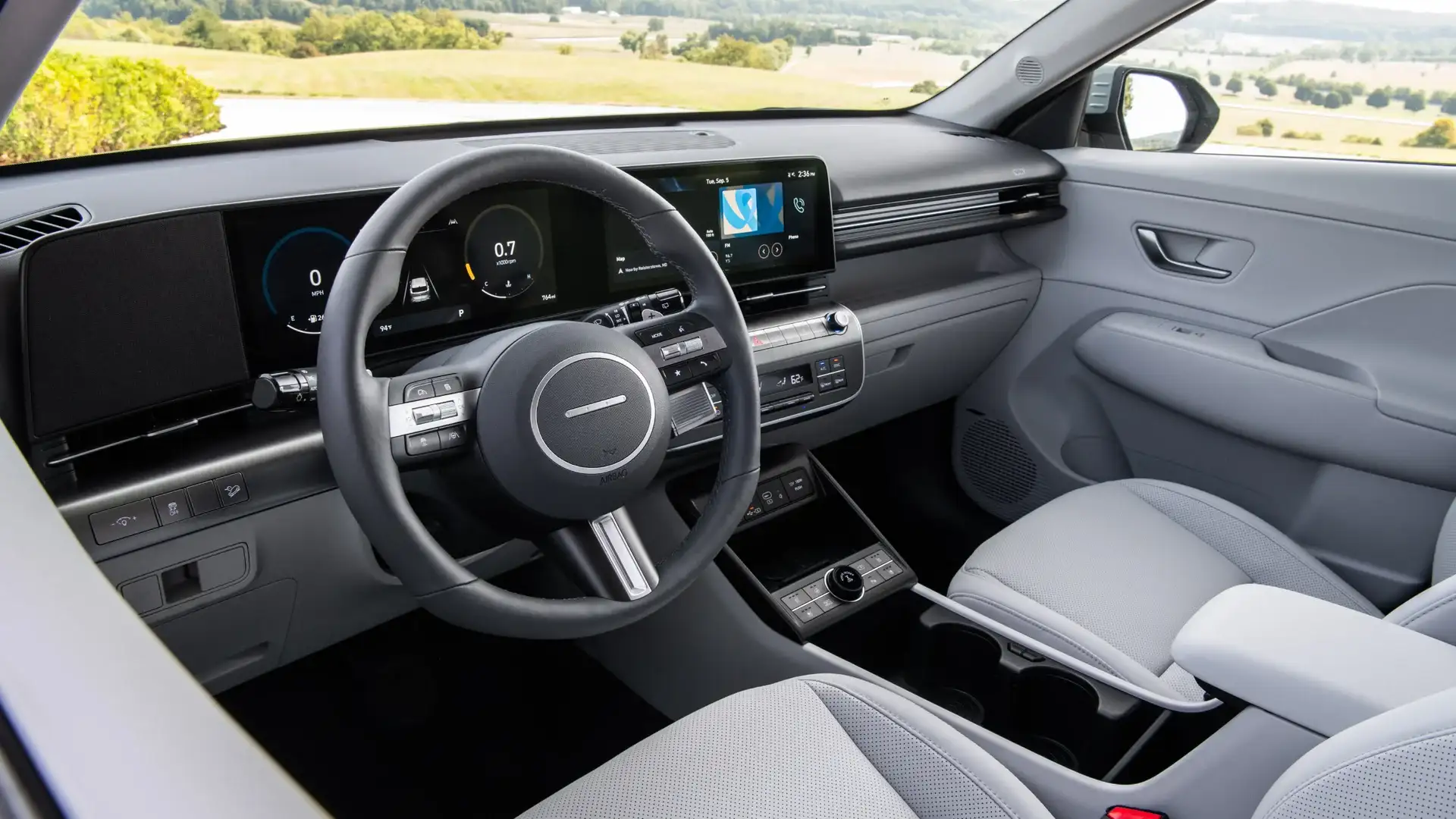 2027 Hyundai Kona interior with light front seats, digital display, and center console controls.