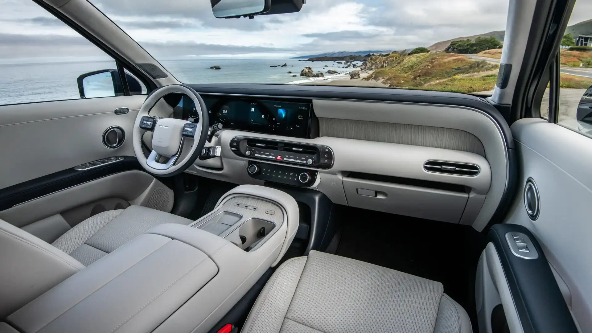 2027 Hyundai Palisade light interior with dashboard, touchscreen, and coastal view through windshield.