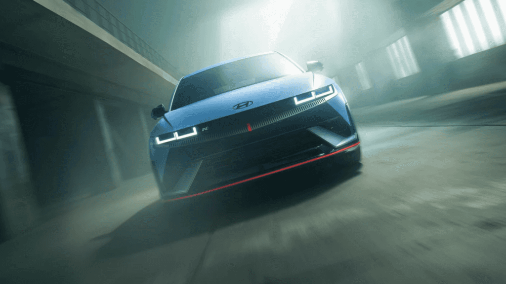 Aggressive front view of the 2025 Hyundai IONIQ 5 N in blue with LED headlights in a tunnel.