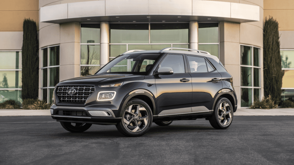 2025 Hyundai Venue compact SUV parked outside modern building with LED lights on.