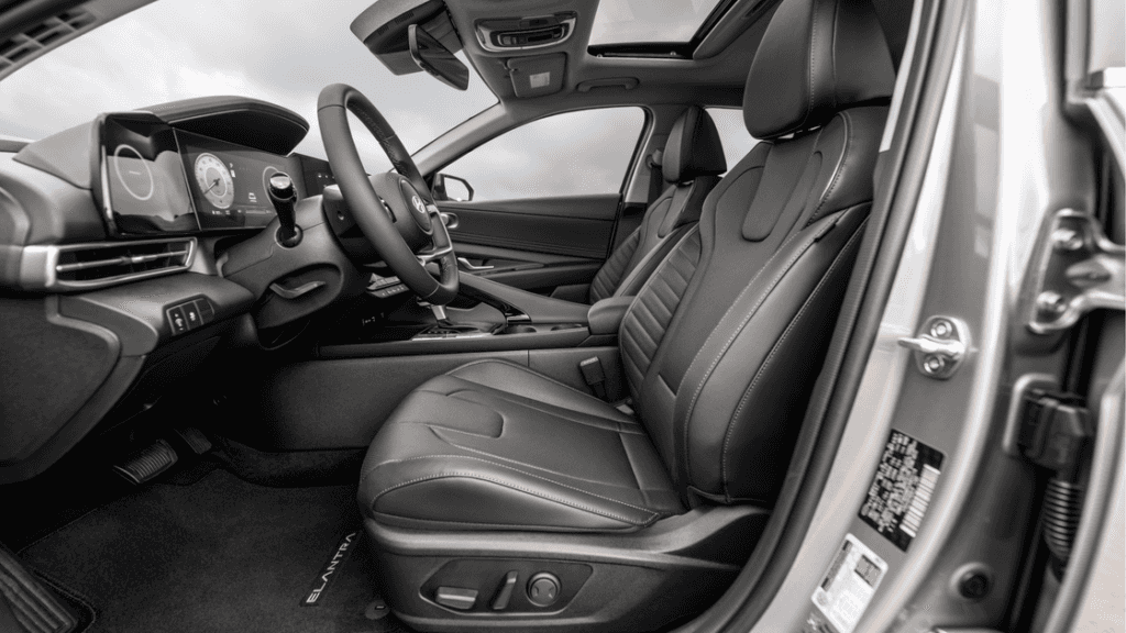 Front seats and dash of the 2025 Hyundai Elantra with leather upholstery and sunroof.