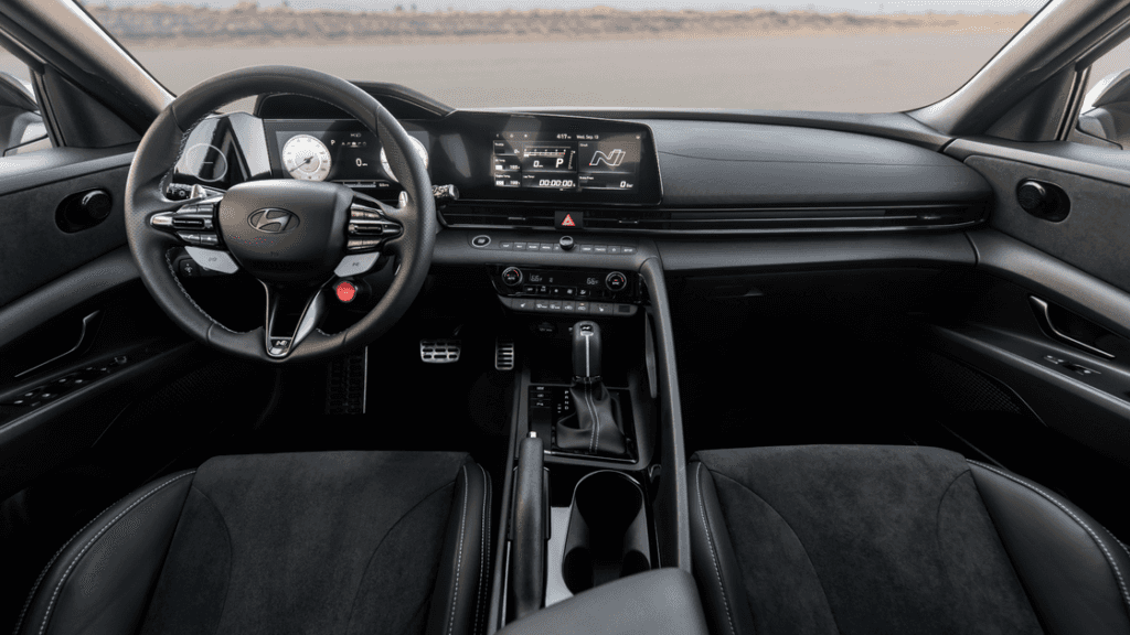 Sporty interior of 2025 Elantra N featuring paddle shifters and flat-bottom steering wheel.