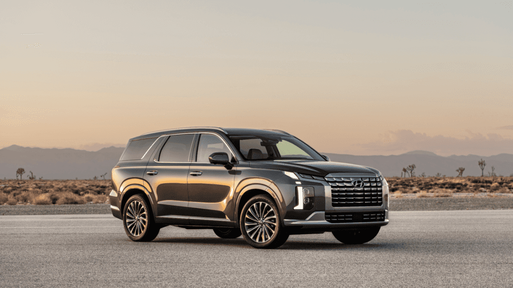 2025 Hyundai Palisade SUV parked at sunset with desert landscape in the background.