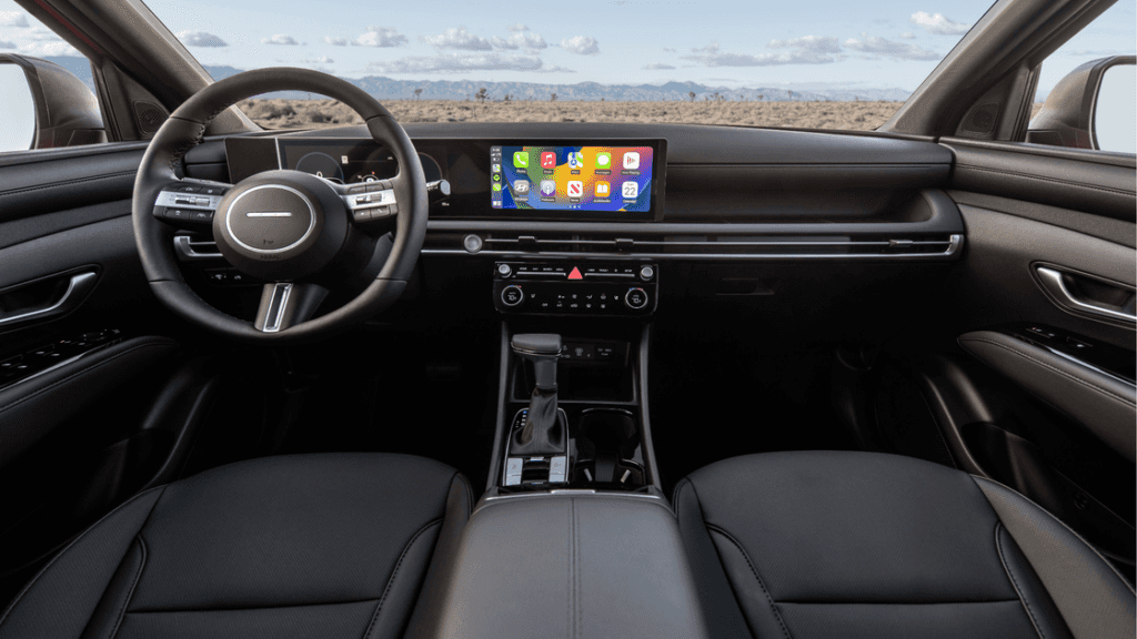 Interior of the 2025 Hyundai Santa Cruz featuring digital display with Apple CarPlay and black trim.