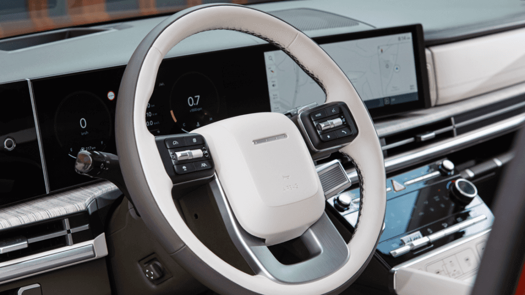 Close-up of the 2025 Hyundai Santa Fe’s white leather-wrapped steering wheel with digital displays.