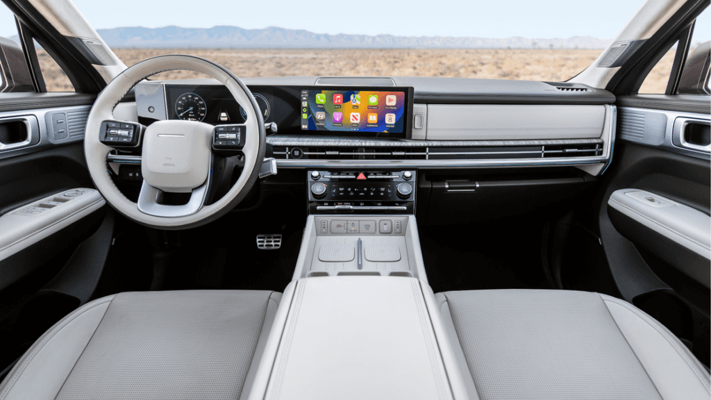 2025 Hyundai Santa Fe Hybrid interior with panoramic touchscreen display and two-tone leather trim.