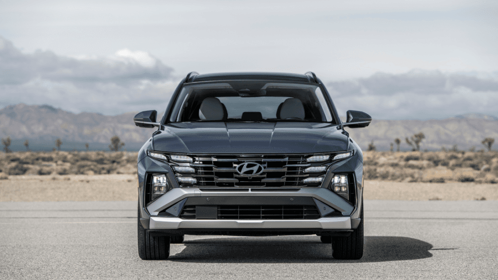 Front view of 2025 Hyundai Tucson SUV parked outdoors with signature LED headlights and grille.