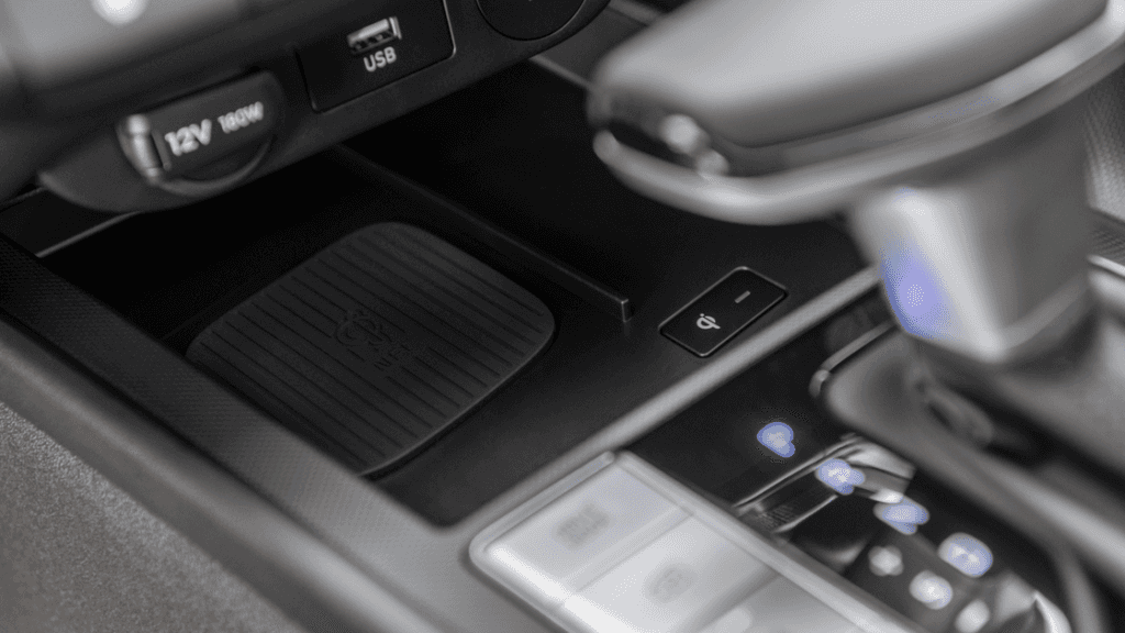 Wireless charging pad and gear selector in 2025 Hyundai Elantra center console layout.
