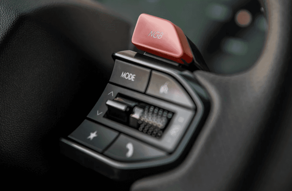 Close-up of the NGB button and drive mode controls on the 2025 Hyundai IONIQ 5 N steering wheel.