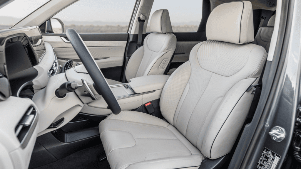 Front seats and dashboard of the 2025 Hyundai Palisade showcasing premium beige leather interior.