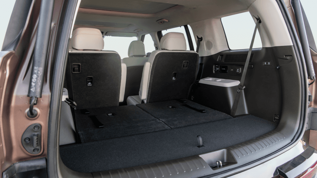 2025 Hyundai Santa Fe Hybrid driving on desert road showcasing its rugged, modern exterior design.