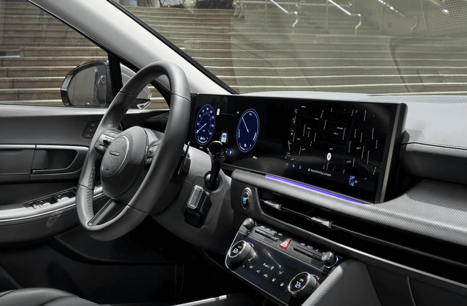 Driver cockpit of the 2025 Hyundai Sonata featuring a wide touchscreen display and digital gauges.