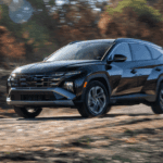 2025 Hyundai Tucson Hybrid in black driving off-road through a forest trail with motion blur effects.