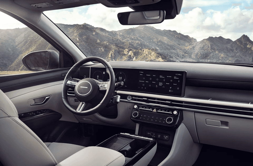 2025 Hyundai Tucson Plug-in Hybrid front cabin with touchscreen display and mountain background.