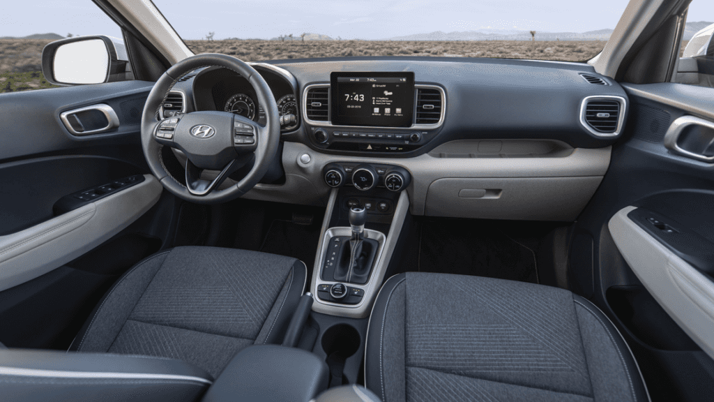 Interior view of the 2025 Hyundai Venue showcasing dashboard layout, infotainment system, and front seats.